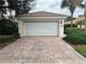 View of the brick paver driveway leading to the attached garage at 11943 Iselle Dr, Orlando, FL 32827