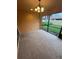 View of the screened-in lanai featuring tan walls, carpet flooring, and a light fixture at 11943 Iselle Dr, Orlando, FL 32827