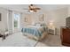 Well-lit bedroom with a comfortable bed, neutral decor, and ample natural light at 12335 Se 176Th Loop, Summerfield, FL 34491