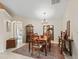 Formal dining room with chandelier, table with six chairs, and decorative furniture at 12335 Se 176Th Loop, Summerfield, FL 34491