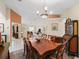 Spacious dining room with natural light, chandelier, and doorway leading to the living room at 12335 Se 176Th Loop, Summerfield, FL 34491