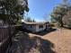 Rear view of the home featuring a wooden fence, a sunroom and a spacious lot at 13 Spring Loop, Ocala, FL 34472