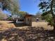 Back of home showing backyard, enclosed sunroom, and brick exterior at 13 Spring Loop, Ocala, FL 34472