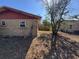 Side view of fenced backyard and exterior of home on a sunny day at 13 Spring Loop, Ocala, FL 34472