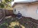 View of the home's side and backyard with an installed air conditioning unit at 13 Spring Loop, Ocala, FL 34472