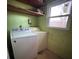 Laundry room featuring a window, open shelving, washer and dryer hookups at 13 Spring Loop, Ocala, FL 34472