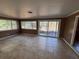 Bright living room with tiled floors and sliding glass doors to the backyard at 13 Spring Loop, Ocala, FL 34472