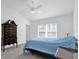 Bright bedroom featuring a ceiling fan, light gray carpet, and a beautiful antique dresser at 1392 Kenneth St, The Villages, FL 34762