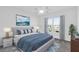 Bright bedroom with a large window, plush carpeting, stylish furnishings, and a soothing blue color scheme at 1392 Kenneth St, The Villages, FL 34762