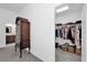 View of closet near to an ensuite bathroom with a large dresser placed outside it at 1392 Kenneth St, The Villages, FL 34762