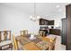 Inviting dining area featuring a stylish chandelier and a view into the modern kitchen at 1392 Kenneth St, The Villages, FL 34762