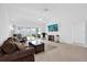 Cozy living room featuring tile floors, access to a screened patio, and comfortable furniture at 1392 Kenneth St, The Villages, FL 34762