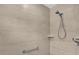 Modern shower featuring neutral-colored tiles, a handheld shower head, and a built-in shelf at 1392 Kenneth St, The Villages, FL 34762