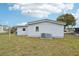 Backyard featuring a well-maintained lawn, the back of the house, and a fence at 1430 Mohawk Cir, Tavares, FL 32778