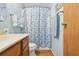 Bathroom featuring a shower/tub combo with a white and blue shower curtain at 1430 Mohawk Cir, Tavares, FL 32778