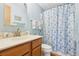 Bathroom featuring a shower/tub combo with a white and blue shower curtain at 1430 Mohawk Cir, Tavares, FL 32778