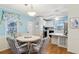 Dining area connected to kitchen features laminate floors and bright blue accents at 1430 Mohawk Cir, Tavares, FL 32778