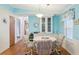 Dining area features blue walls, wood floors, and a view into other rooms at 1430 Mohawk Cir, Tavares, FL 32778