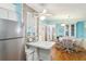 Kitchen with a view into dining area, white cabinets, and stainless steel refrigerator at 1430 Mohawk Cir, Tavares, FL 32778