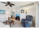 Bright living room features white furniture, carpet, and a decorative ceiling fan at 1430 Mohawk Cir, Tavares, FL 32778