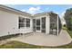 Backyard with a screened-in lanai, bench, and well-maintained lawn offering a relaxing outdoor space at 1508 Dellano Way, The Villages, FL 32159