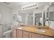 Bathroom featuring double sinks, granite countertops, and a large mirror at 1508 Dellano Way, The Villages, FL 32159