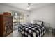 Bright bedroom with tiled floors, a ceiling fan, and a sliding glass door to a patio at 1508 Dellano Way, The Villages, FL 32159