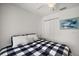 Well-lit bedroom featuring neutral colors and a closet with a matching blue and white bed spread at 1508 Dellano Way, The Villages, FL 32159