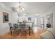 Well-lit dining area adjacent to the kitchen, complete with stylish chairs and glass top table at 1508 Dellano Way, The Villages, FL 32159