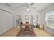 Home office with hardwood flooring, white shelving, and bright natural light at 1508 Dellano Way, The Villages, FL 32159