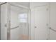 Bathroom shower with glass door and accessibility grab bar at 1508 Dellano Way, The Villages, FL 32159