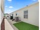 Exterior of home showing patio and artificial turf and walkway to the back of the property at 1558 Summerchase Loop, The Villages, FL 32162