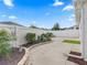 Backyard landscaping with manicured planting beds, decorative rock, and well-maintained yard at 1558 Summerchase Loop, The Villages, FL 32162