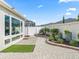 Backyard with decorative rock, artificial turf, and view of the sunroom windows at 1558 Summerchase Loop, The Villages, FL 32162