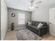 Cozy spare bedroom with a comfortable sofa, neutral tones, and natural light from the window at 1558 Summerchase Loop, The Villages, FL 32162