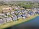 An aerial view of a lakeside community with a pond, horse stables, and mature trees at 16126 Bristol Lake Cir, Orlando, FL 32828