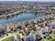 Panoramic aerial view of a neighborhood showcasing homes near a large, tranquil lake at 16126 Bristol Lake Cir, Orlando, FL 32828