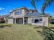 Expansive backyard showcasing the home's screened patio, large windows, and well-maintained lawn at 16126 Bristol Lake Cir, Orlando, FL 32828