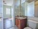 Granite countertop vanity featuring mirrors and natural light from window in bright bathroom at 16126 Bristol Lake Cir, Orlando, FL 32828