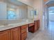 Bathroom with double sink vanity with light countertops and a large mirror at 16126 Bristol Lake Cir, Orlando, FL 32828