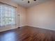 Bedroom with hardwood floors, window and peach colored walls at 16126 Bristol Lake Cir, Orlando, FL 32828