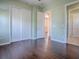 Bedroom with hardwood floors, double door closet, and doorway to other rooms at 16126 Bristol Lake Cir, Orlando, FL 32828