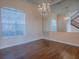 Elegant dining room featuring hardwood floors, a chandelier, large mirror, and window with blinds at 16126 Bristol Lake Cir, Orlando, FL 32828