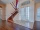 Bright foyer featuring double doors, a staircase with iron railing, tile floors, and natural light at 16126 Bristol Lake Cir, Orlando, FL 32828