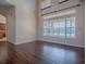 Spacious living room with hardwood floors, large windows offering a scenic view, and plenty of natural light at 16126 Bristol Lake Cir, Orlando, FL 32828