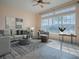 The living room is staged and features large windows offering scenic views and natural light at 16126 Bristol Lake Cir, Orlando, FL 32828