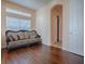 Cozy living room featuring an elegant couch, arched doorway, and a view of the closet at 16126 Bristol Lake Cir, Orlando, FL 32828