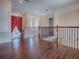 Open loft area boasts beautiful hardwood floors, wood banister and natural light from the large windows at 16126 Bristol Lake Cir, Orlando, FL 32828