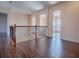 Bright and open loft space featuring dark wood floors, archways and wood and metal banister at 16126 Bristol Lake Cir, Orlando, FL 32828