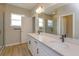 Modern bathroom featuring double sinks, a large mirror, and a glass-enclosed shower at 16434 Hamlin Hills Rd, Winter Garden, FL 34787